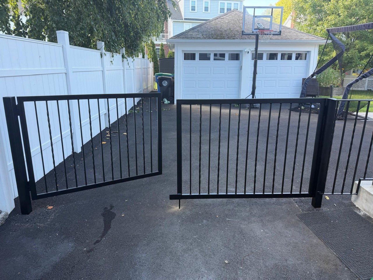 Black steel gate installed at a driveway