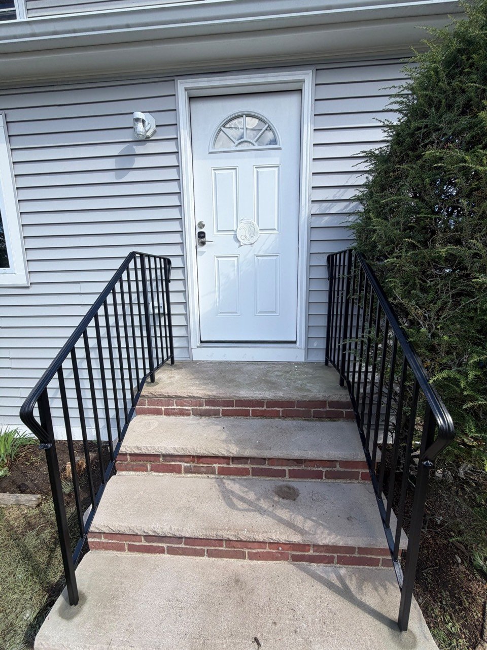 Front door steps with railings