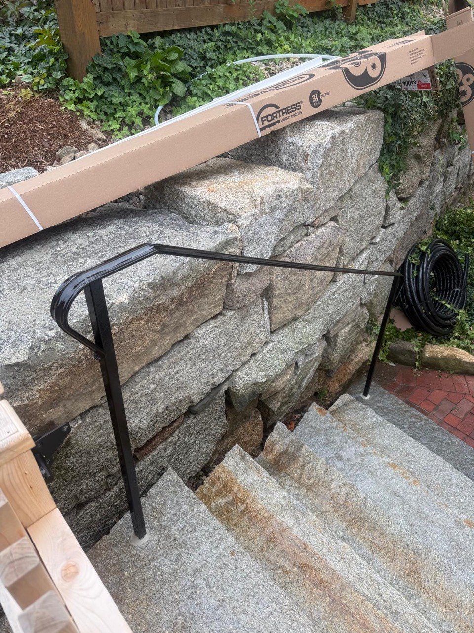 Steel handrail on stone steps